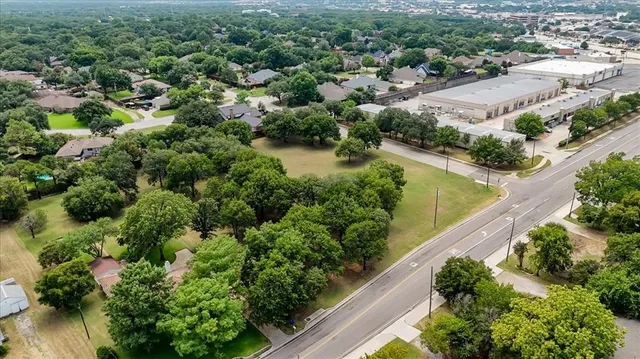 an aerial view of a house with a yard and lake view
