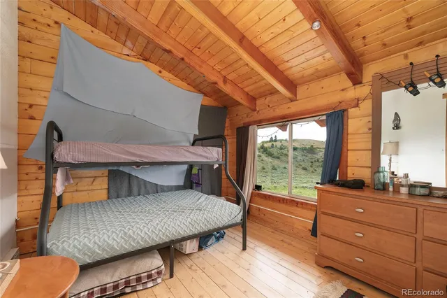 a view of a livingroom with wooden floor and furniture