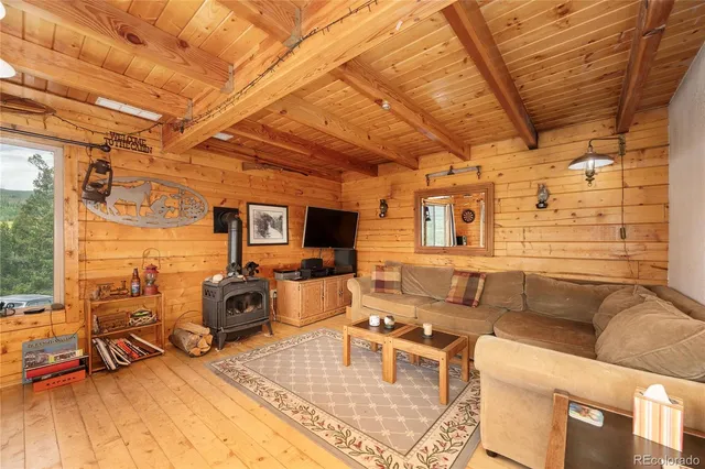 a living room with large trees and a table