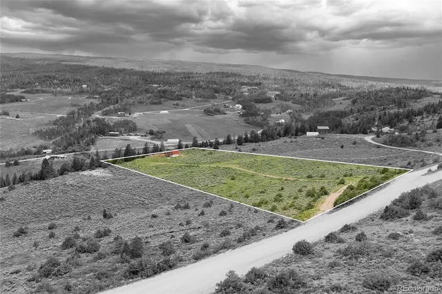 a view of a field with an ocean