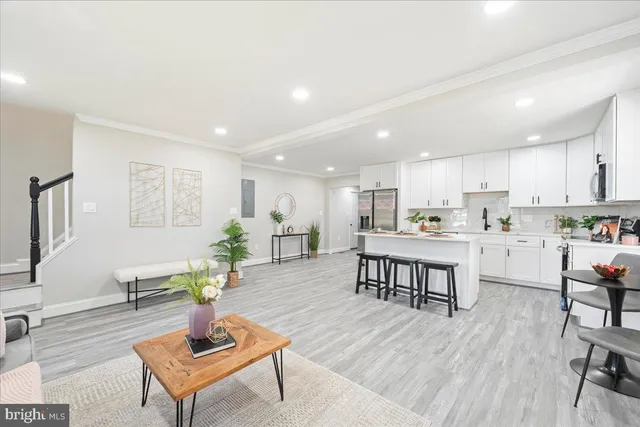 a living room with furniture and kitchen view