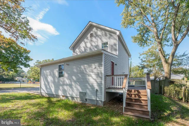 a backyard of a house with a table and chairs
