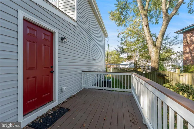 a view of balcony with wooden floor and fence