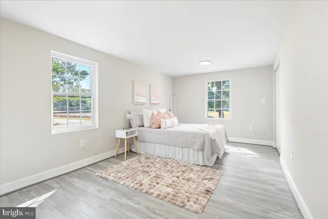 a spacious bedroom with a large bed and a window