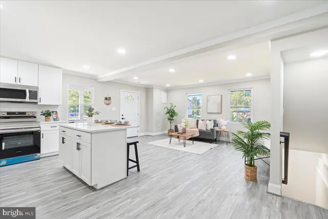 a kitchen with sink stove and cabinets