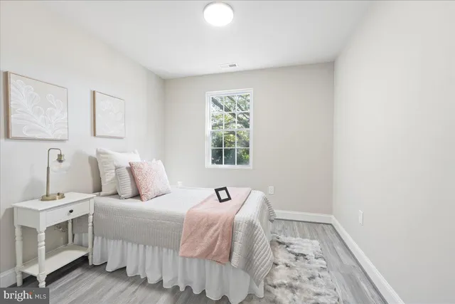 a view of a dining room with furniture and a potted plant