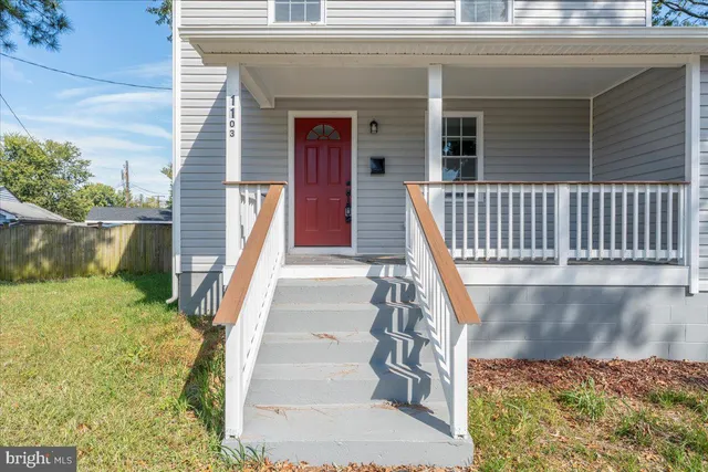 a view of a balcony with wooden floor and fence