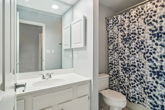 a bedroom with two beds and wooden floor