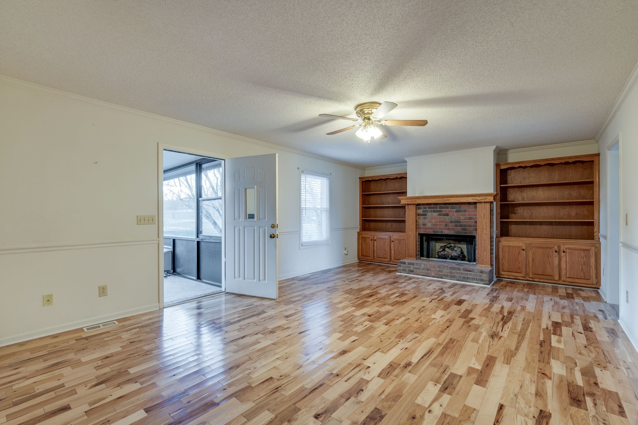 421 Ranch Road Portland, TN 37148 - Photo 11 of 38 a view of a livingroom with a fireplace a chandelier and wooden floor