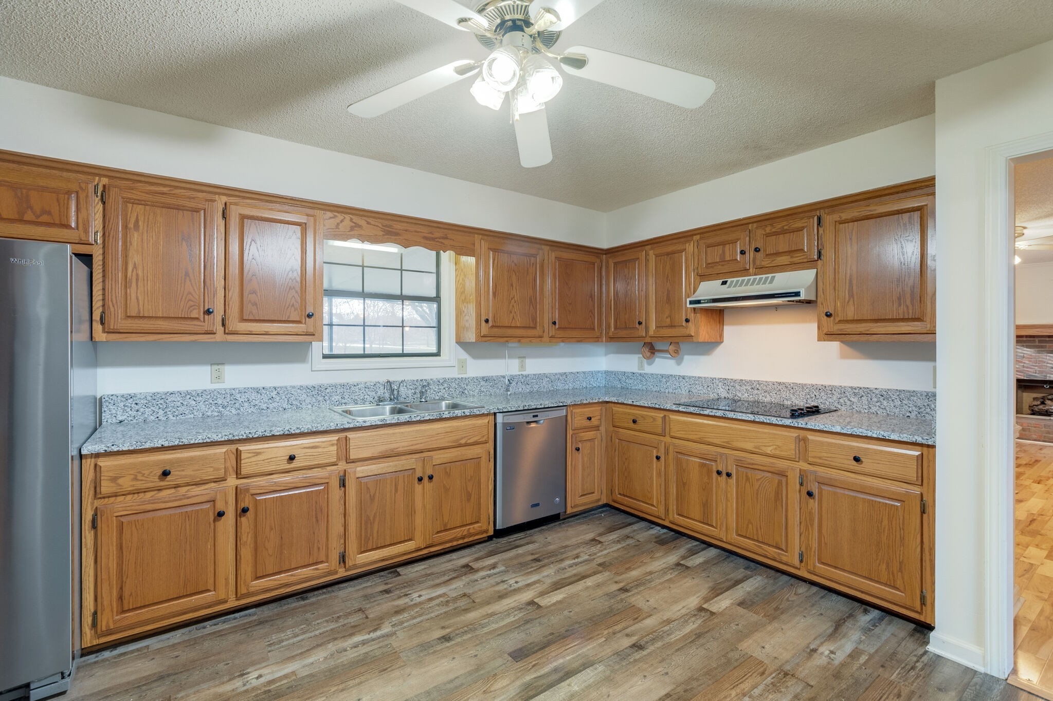 421 Ranch Road Portland, TN 37148 - Photo 14 of 38 a kitchen with granite countertop cabinets stainless steel appliances a sink and a window