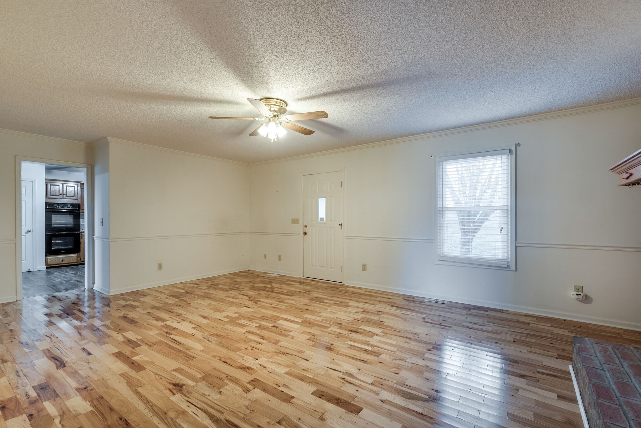 421 Ranch Road Portland, TN 37148 - Photo 9 of 38 a view of an empty room with window and wooden floor