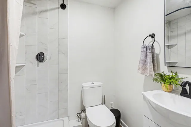 a bathroom with a toilet and a shower