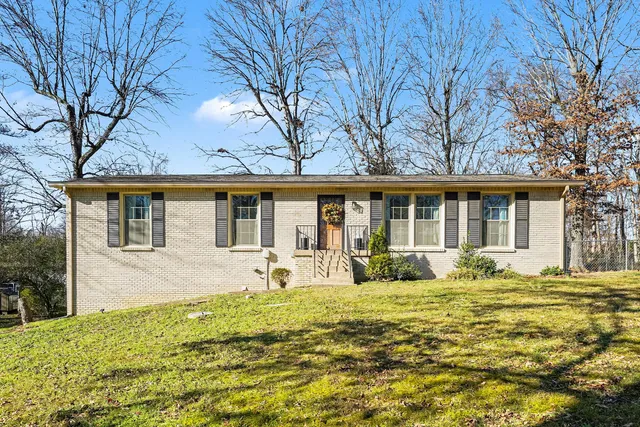 a front view of a house with a yard table and chairs