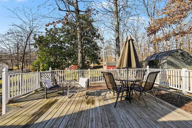 a view of a deck with a table and chairs