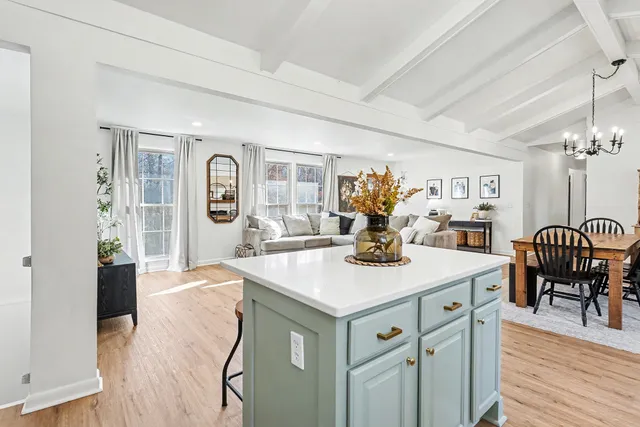 a view of a kitchen area with furniture and wooden floor