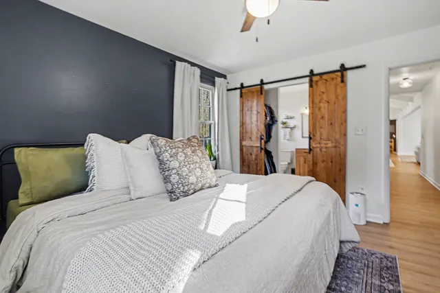 a large bed sitting in a bedroom next to a bathroom