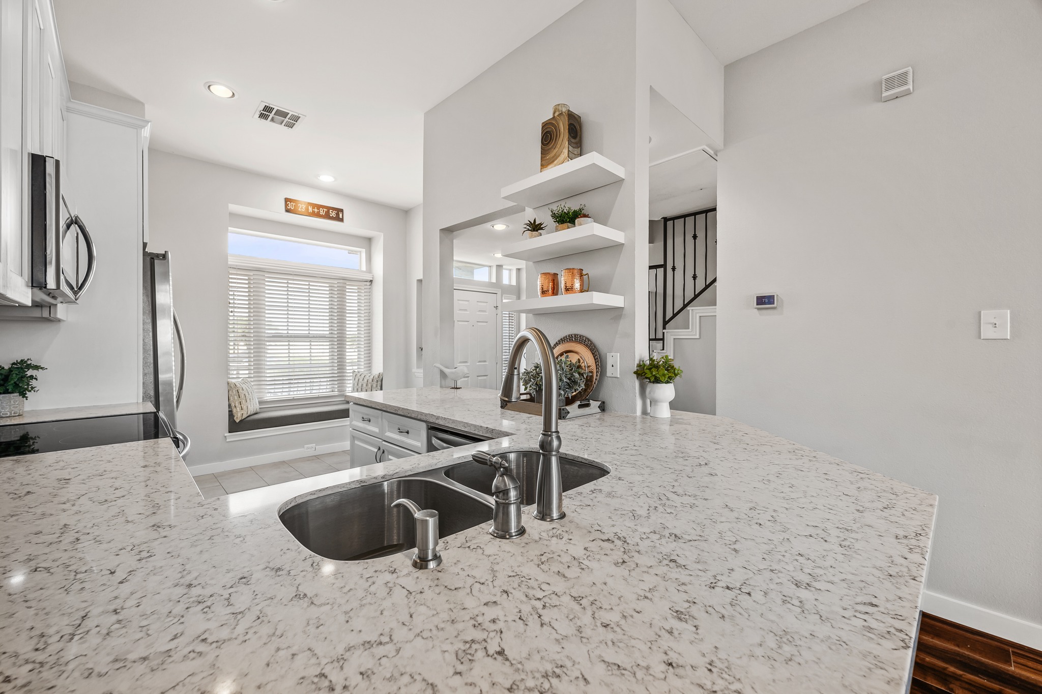 2918 Ranch Road 620 North, Unit S242 Austin, TX 78734 - Photo 10 of 35 Discover a kitchen designed for culinary adventures, featuring a generous kitchen island with a double sink and ample prep space.