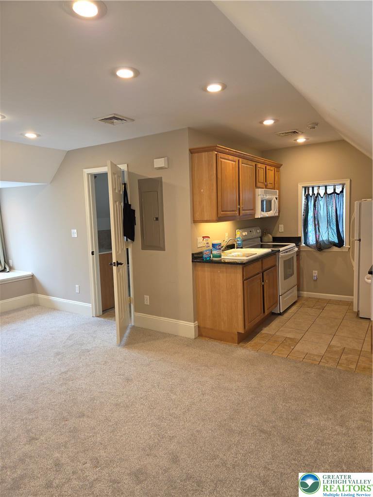 12 West 4th Street, Unit 4 Bethlehem, PA 18015 - Photo 18 of 29 a kitchen with stainless steel appliances granite countertop a stove and a refrigerator