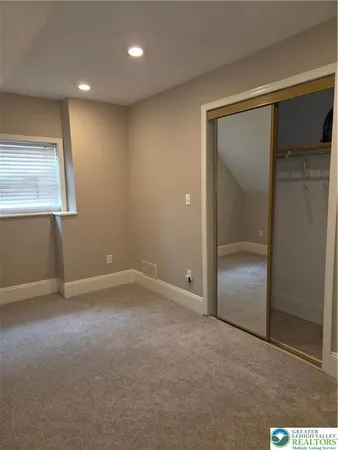 a bedroom with a bed and flat screen tv