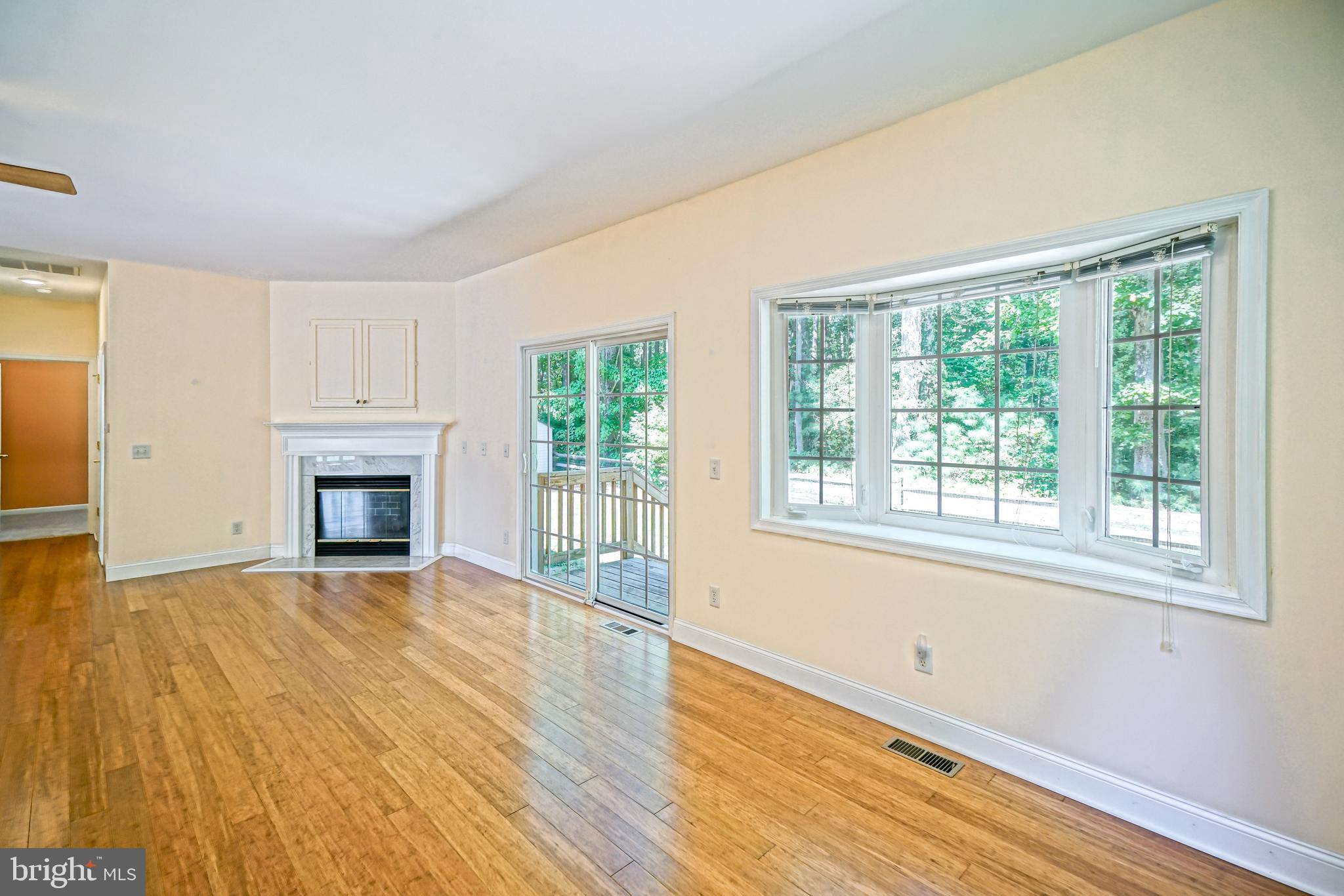 30869 Ridge Court Lewes, DE 19958 - Photo 11 of 42 a view of empty room with wooden floor and fireplace
