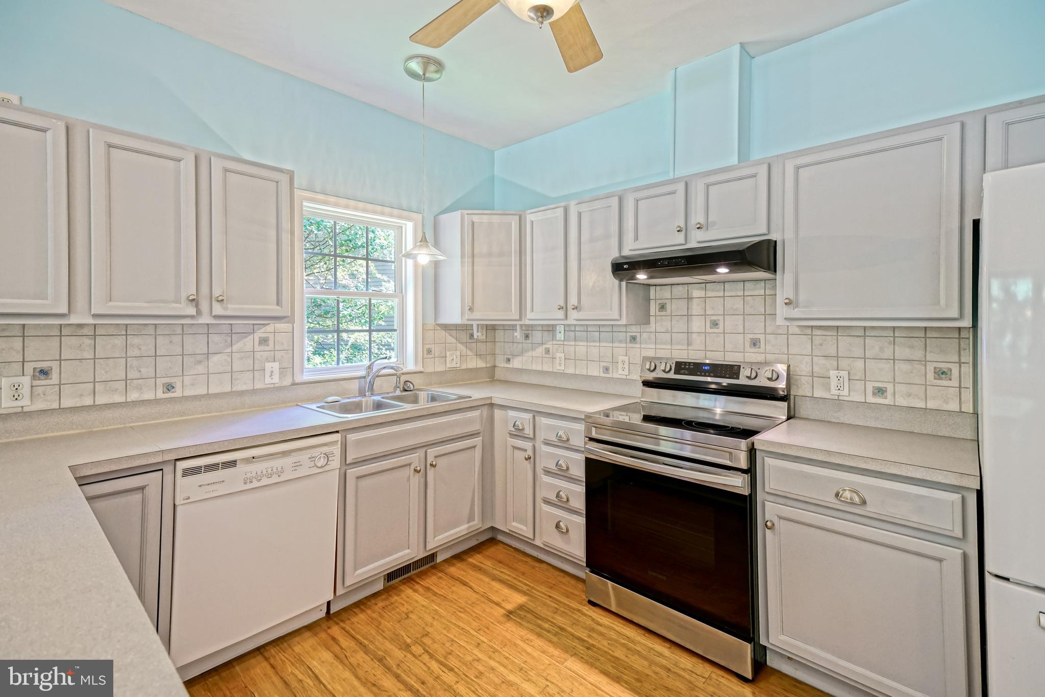30869 Ridge Court Lewes, DE 19958 - Photo 16 of 42 a kitchen with cabinets appliances and a window