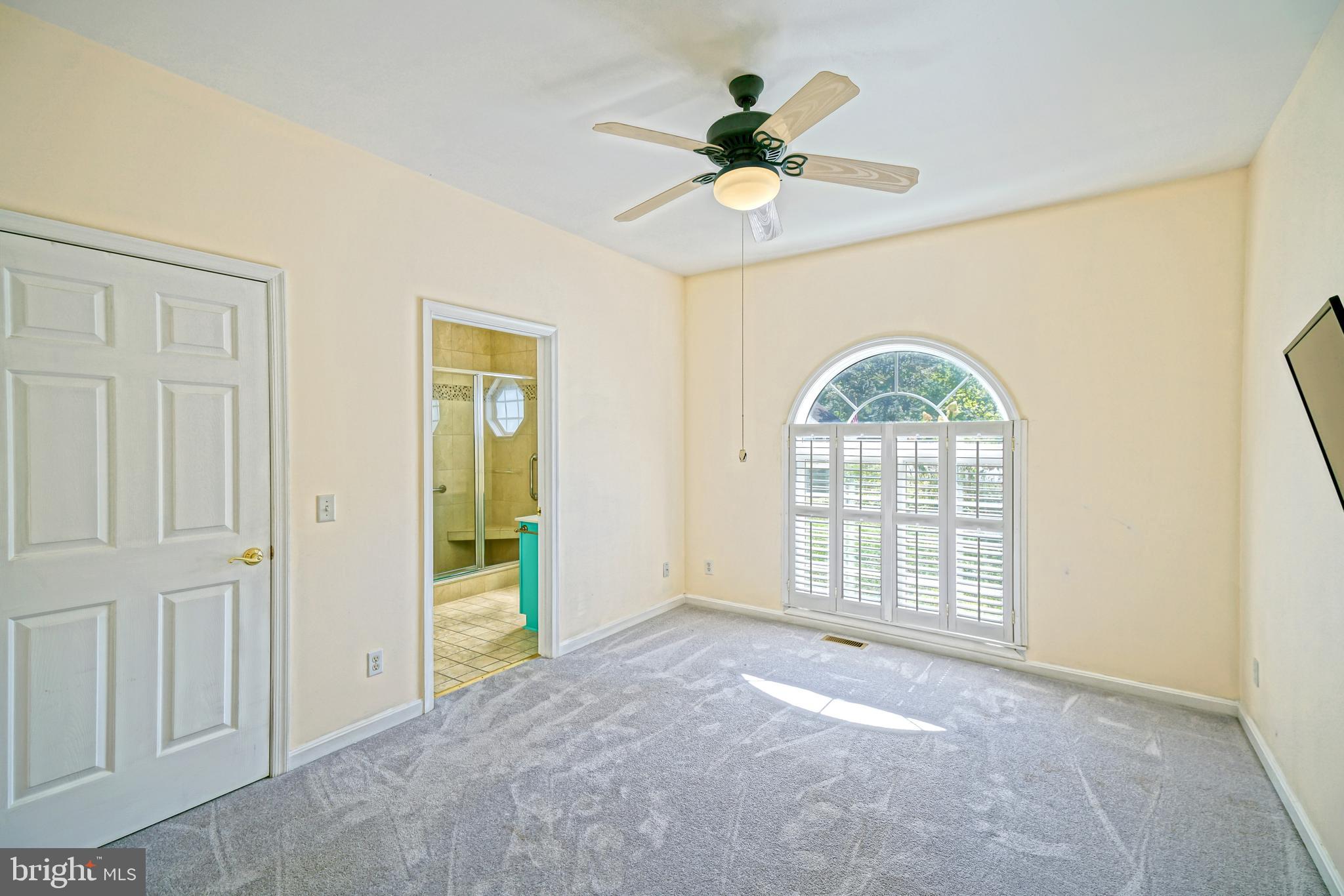 30869 Ridge Court Lewes, DE 19958 - Photo 19 of 42 an empty room with chandelier fan and windows