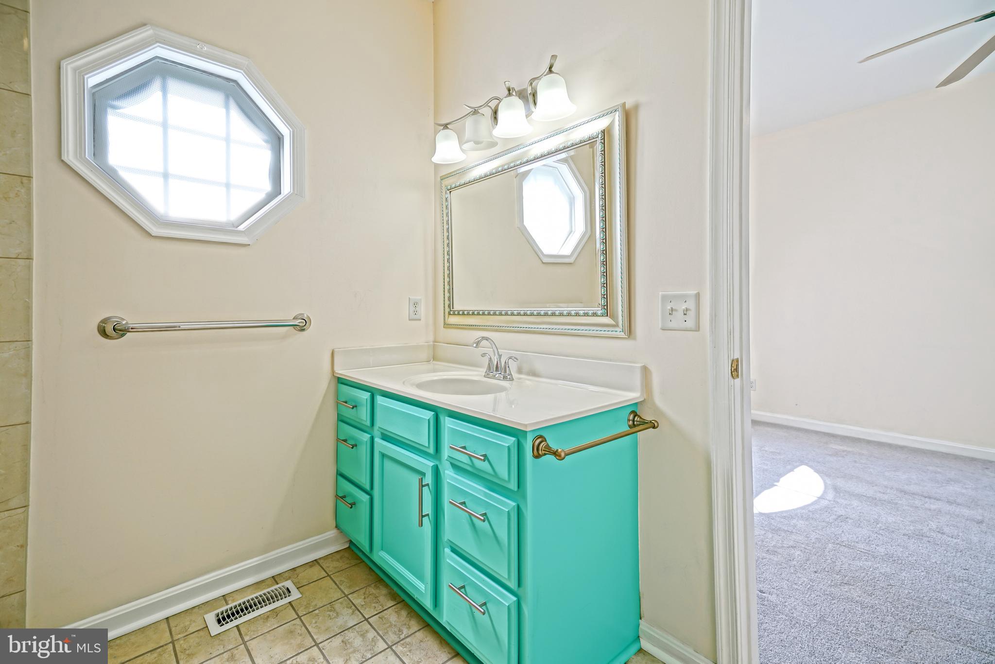 30869 Ridge Court Lewes, DE 19958 - Photo 23 of 42 a bathroom with a sink and a mirror