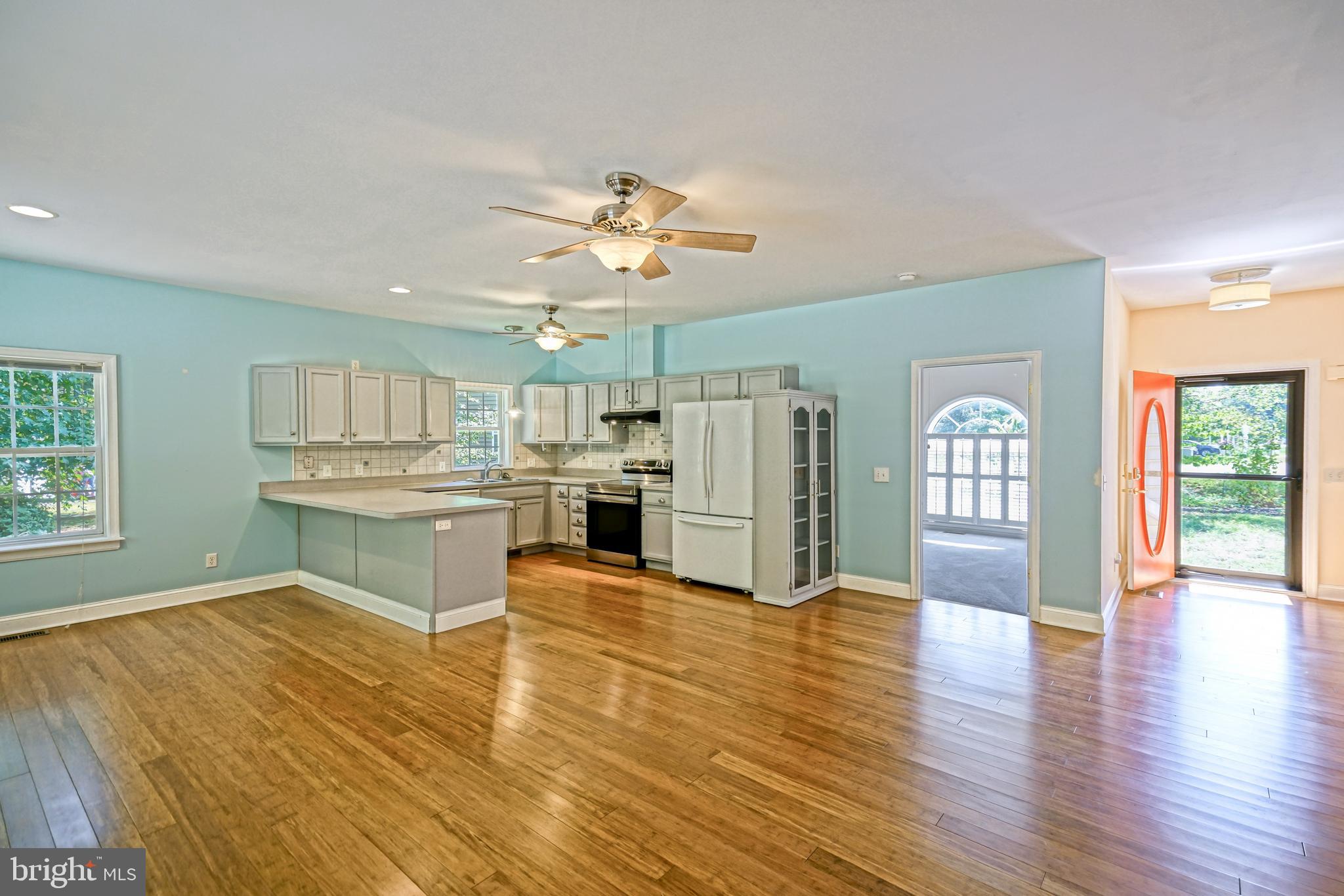 30869 Ridge Court Lewes, DE 19958 - Photo 5 of 42 a view of kitchen with refrigerator stove and wooden floor