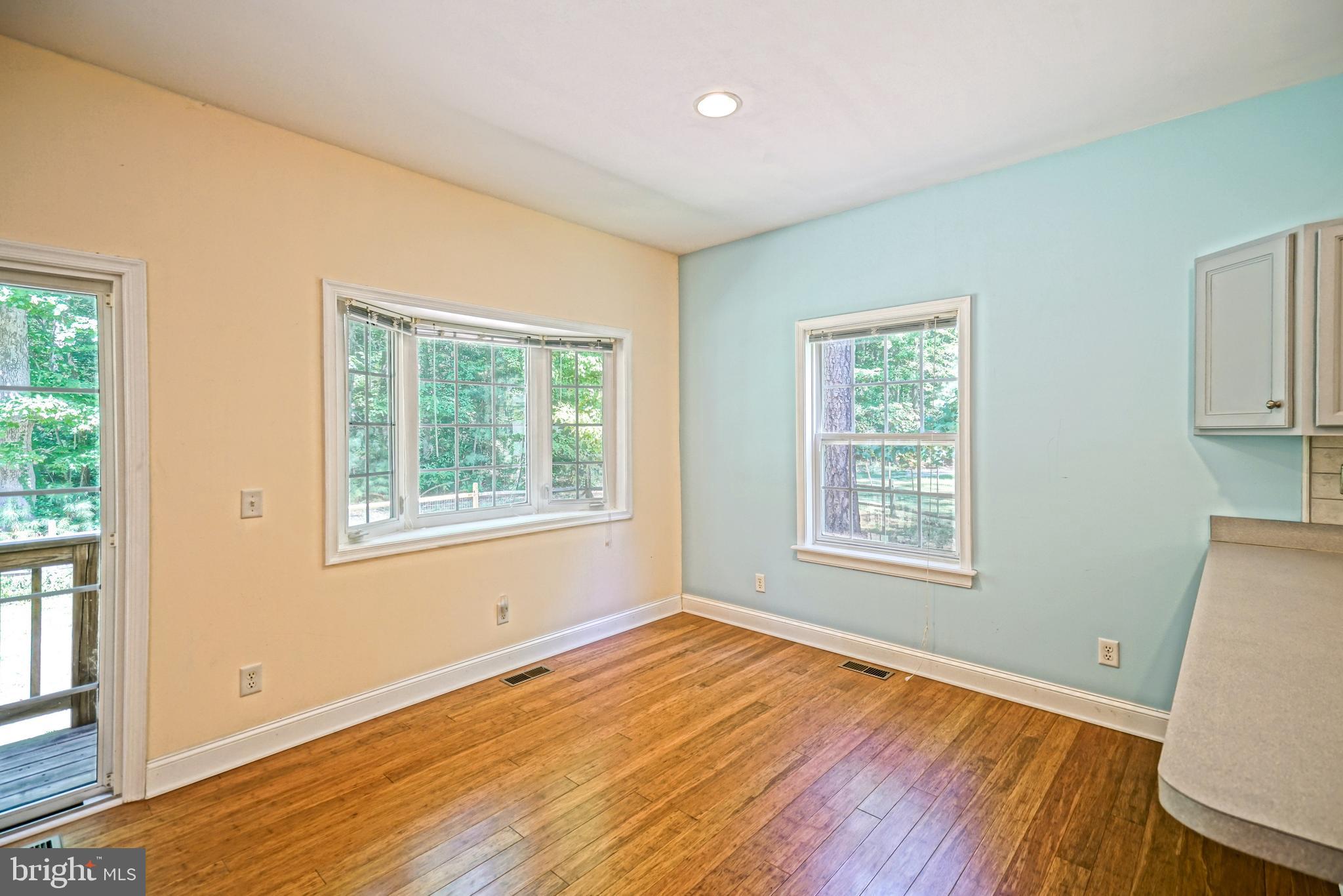 30869 Ridge Court Lewes, DE 19958 - Photo 9 of 42 a view of an empty room with wooden floor and a window
