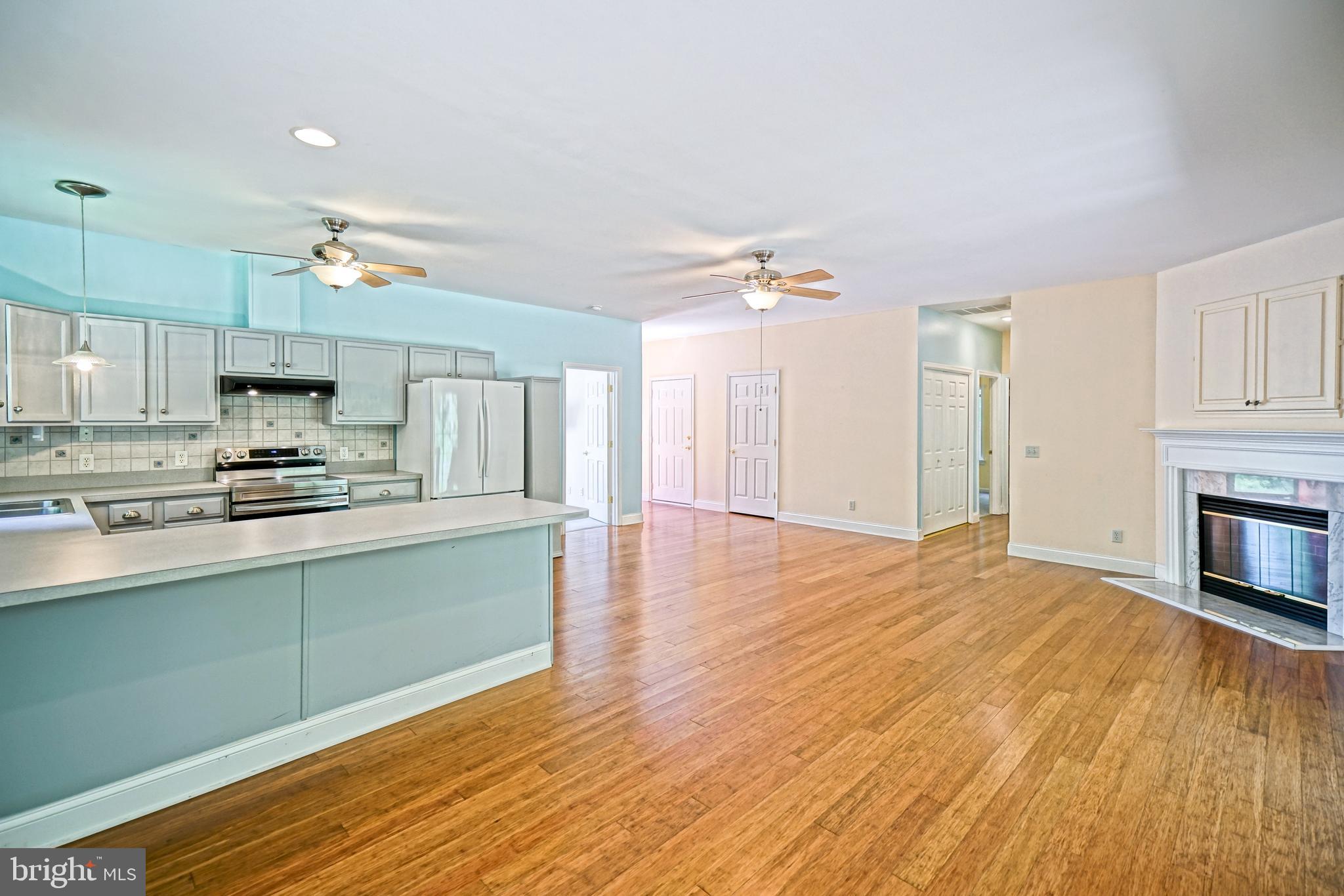 30869 Ridge Court Lewes, DE 19958 - Photo 10 of 42 a kitchen with stainless steel appliances granite countertop a sink cabinets and wooden floor