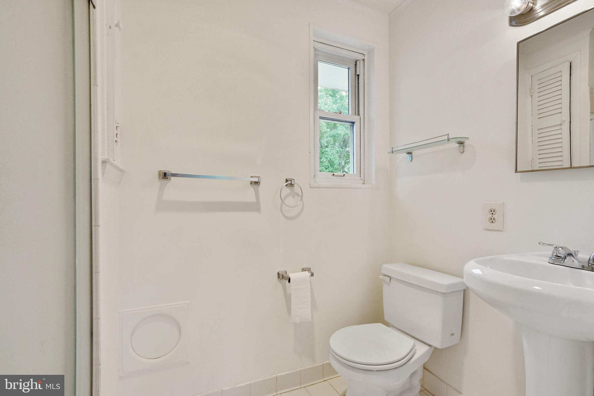 2911 Farm Road Alexandria, VA 22302 - Photo 15 of 35 a white toilet sitting next to a bathroom sink