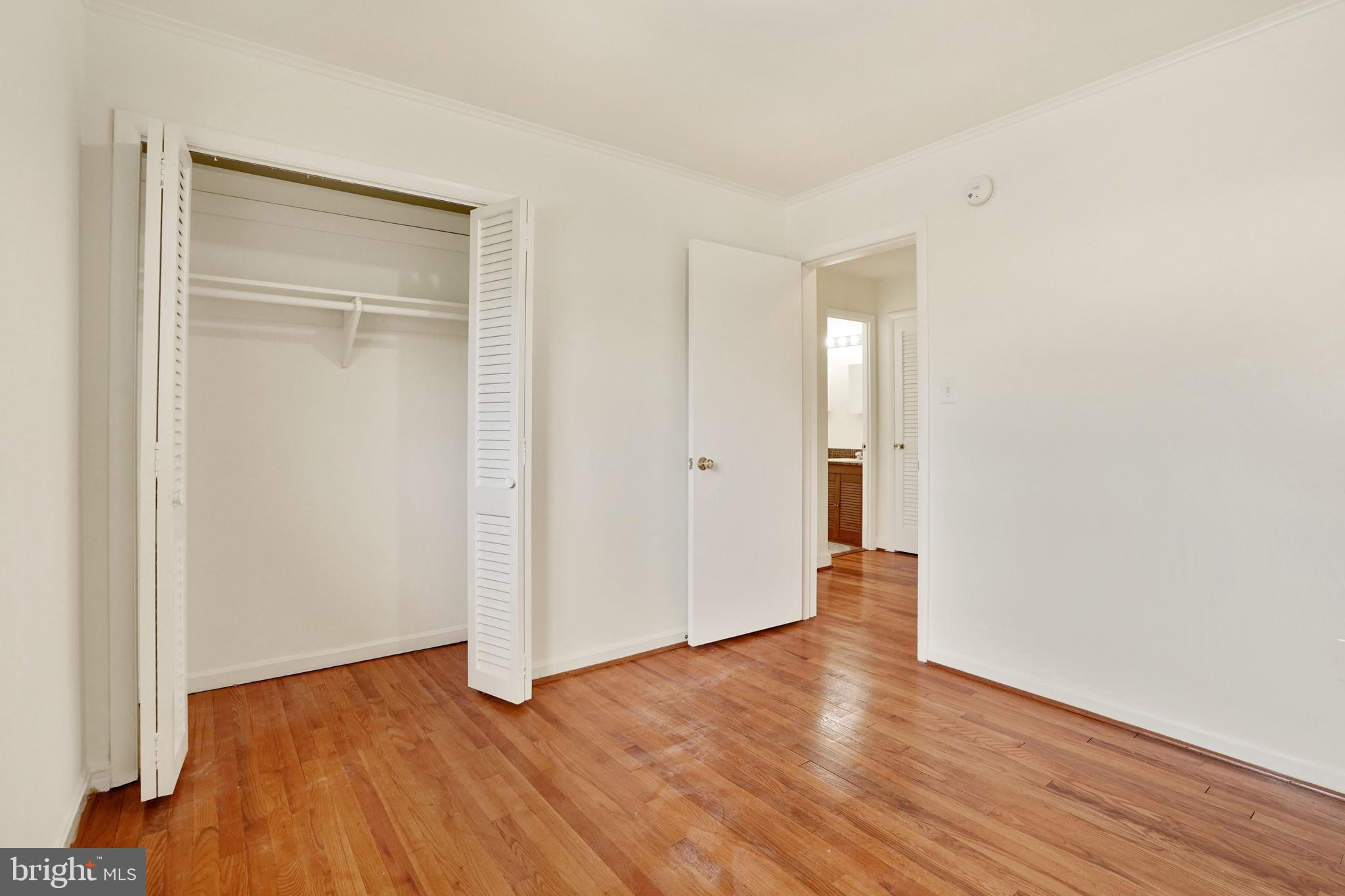 2911 Farm Road Alexandria, VA 22302 - Photo 17 of 35 an empty room with wooden floor & closet and windows