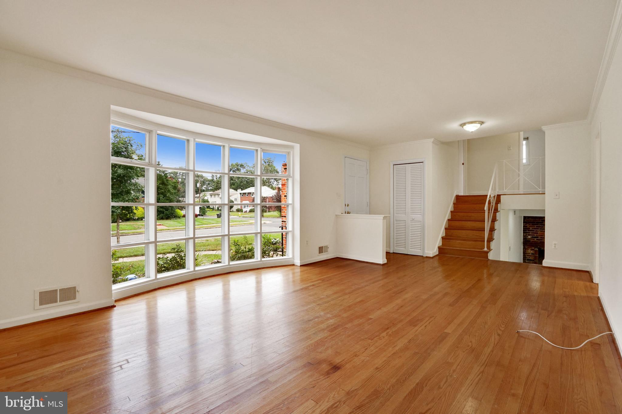 2911 Farm Road Alexandria, VA 22302 - Photo 3 of 35 a view of an empty room with wooden floor and a window