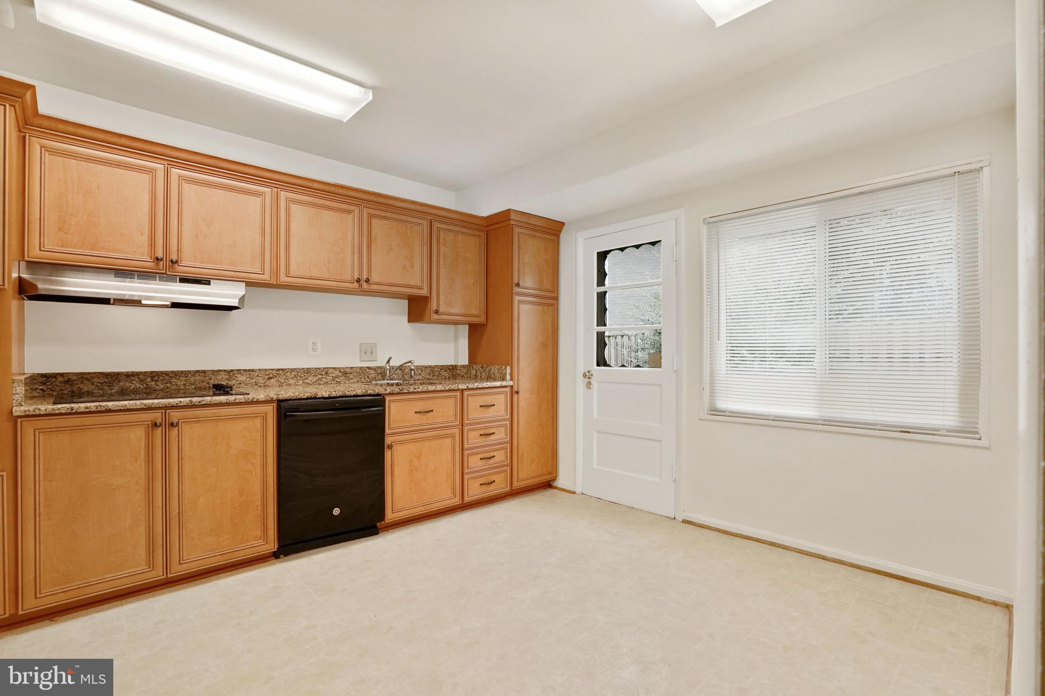 2911 Farm Road Alexandria, VA 22302 - Photo 10 of 35 a kitchen with stainless steel appliances granite countertop a stove a sink and a refrigerator with white cabinets
