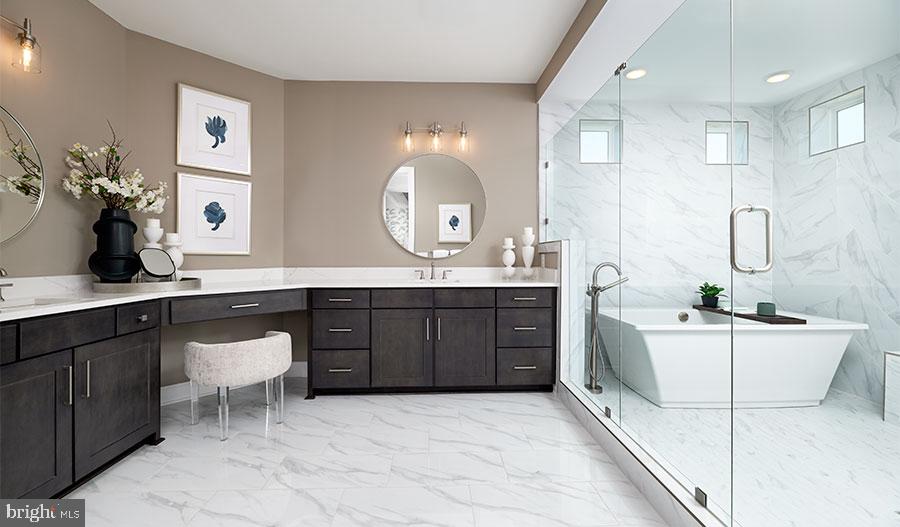 2007 St James Road Accokeek, MD 20607 - Photo 15 of 20 a bathroom with a double vanity sink a large mirror and a bathtub