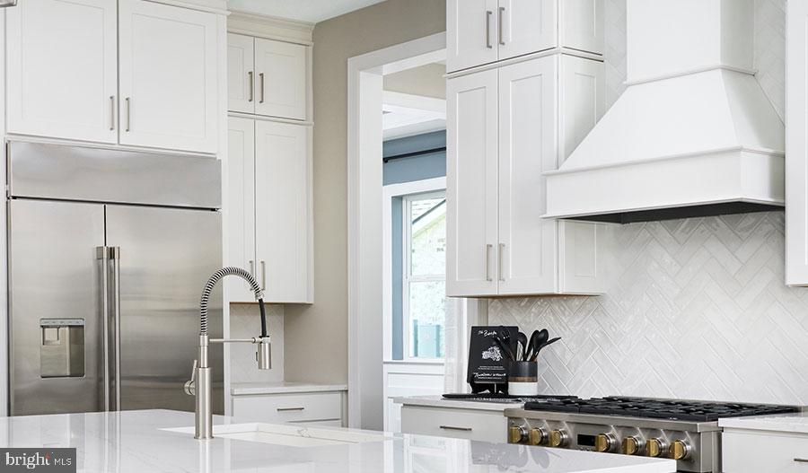 2007 St James Road Accokeek, MD 20607 - Photo 5 of 20 a kitchen with stainless steel appliances granite countertop a refrigerator a stove and white cabinets