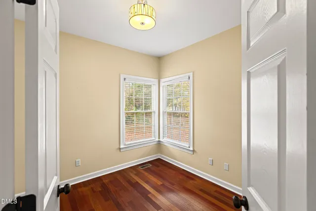a view of room with window and wooden floor