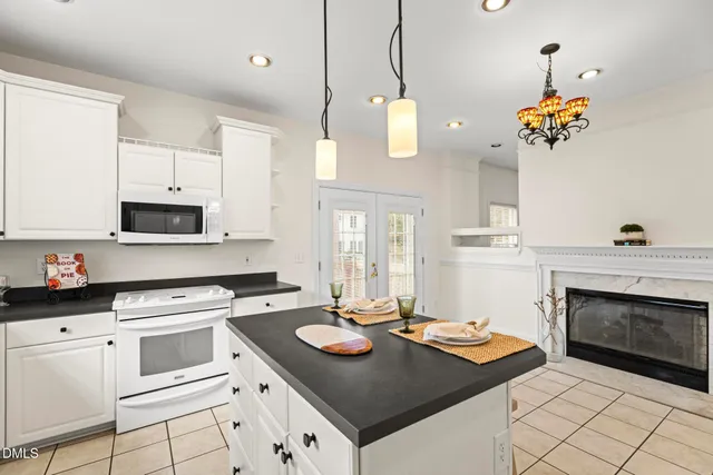 a kitchen with a stove cabinets and window