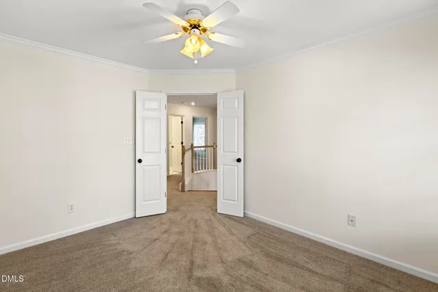 an empty room and a bathroom with a sink