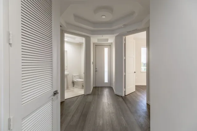 a view of a hallway with wooden floor
