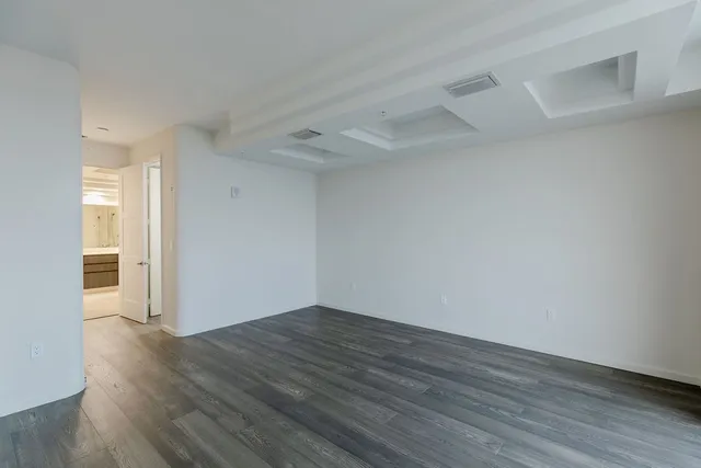 a view of a room with wooden floor