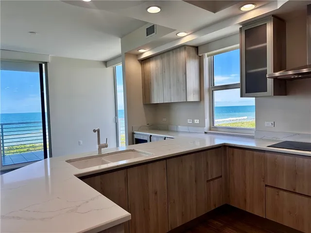 a kitchen that has a sink and a stove in it