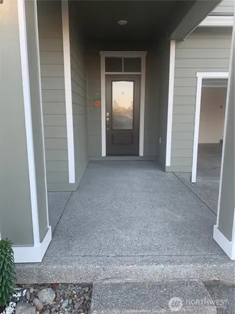 a view of hallway with bathroom and shower