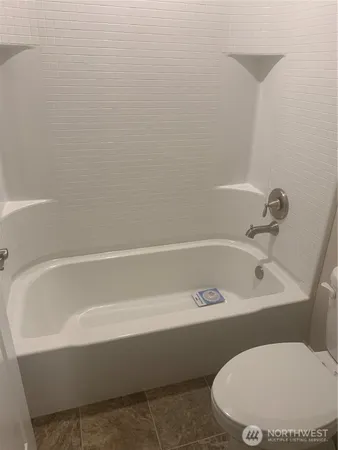 a bathroom with a bathtub and toilet