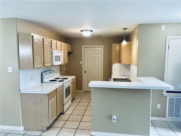 a kitchen with stainless steel appliances granite countertop a sink and a refrigerator