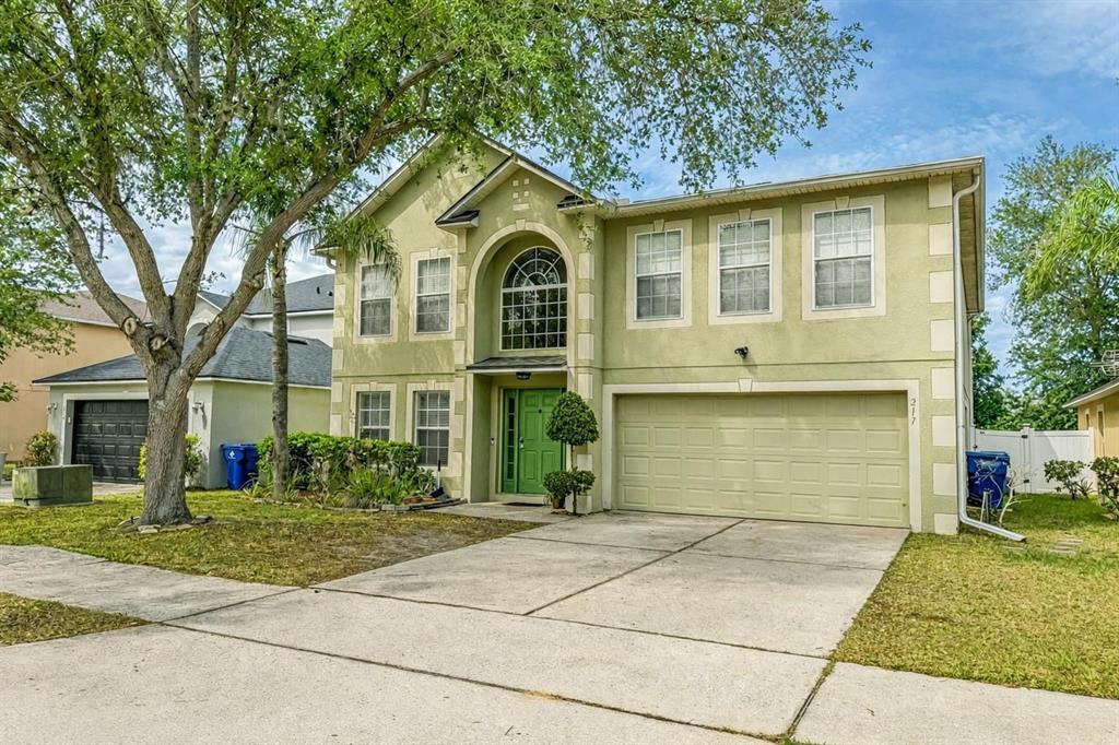 217 Tres Reyes Lane Groveland, FL 34736 - Photo 1 of 20 a front view of a house with a yard