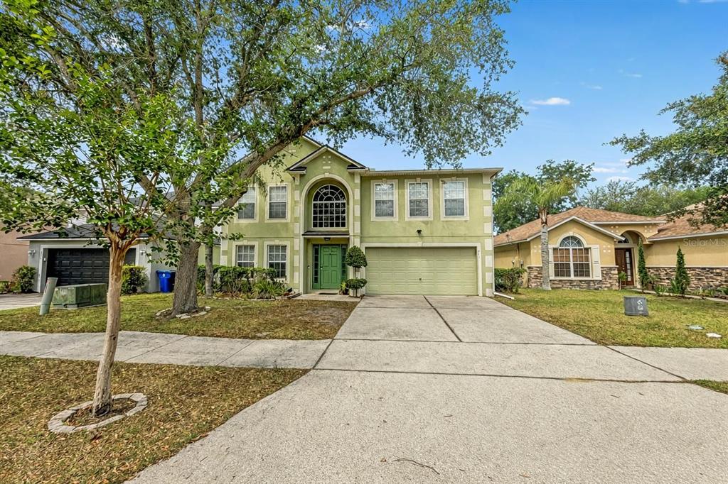 217 Tres Reyes Lane Groveland, FL 34736 - Photo 2 of 20 a front view of a house with garden