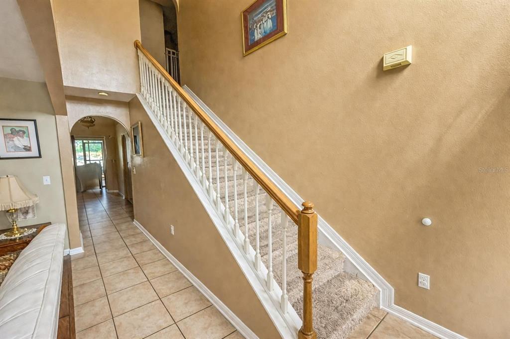 217 Tres Reyes Lane Groveland, FL 34736 - Photo 3 of 20 a view of staircase with railing and a rug