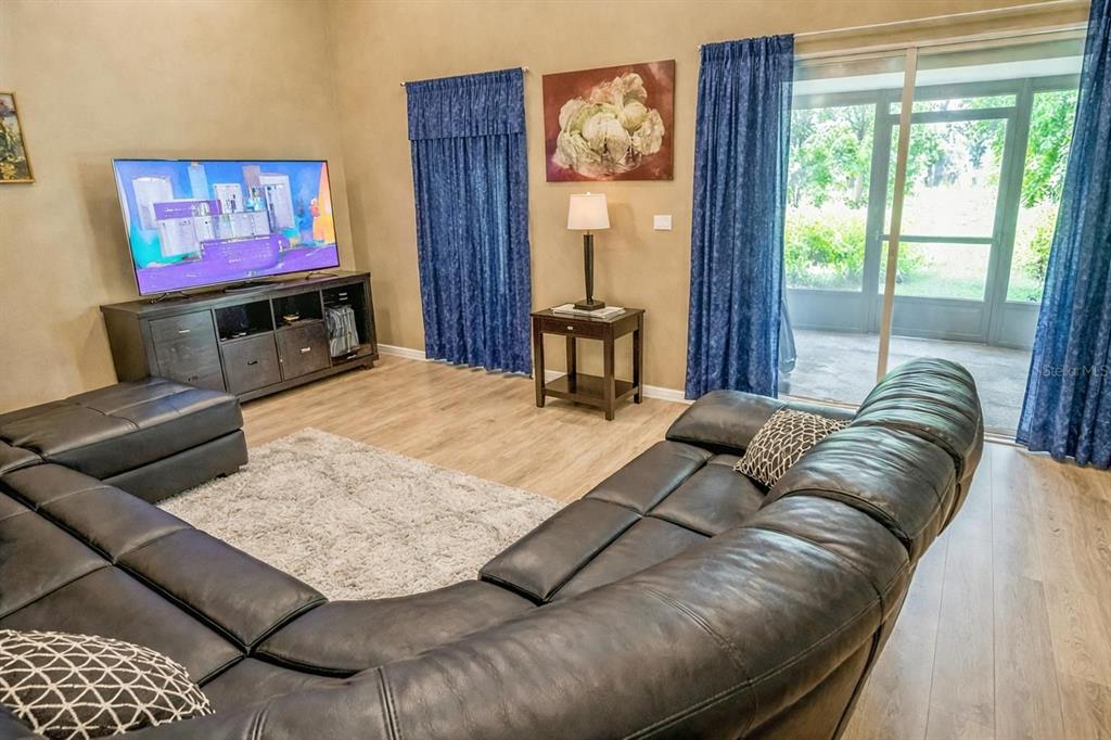 217 Tres Reyes Lane Groveland, FL 34736 - Photo 7 of 20 a living room with furniture and a flat screen tv