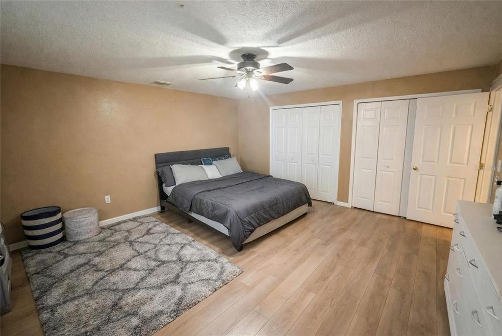 217 Tres Reyes Lane Groveland, FL 34736 - Photo 8 of 20 a bedroom with a bed and ceiling fan